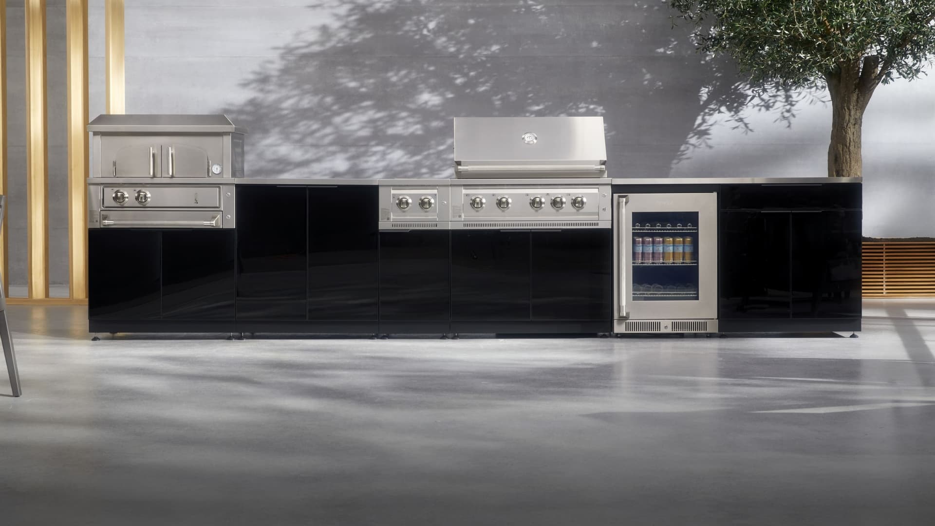 NewAge outdoor kitchen with stone-clad surrounds, a kamado grill and built-in gas grill