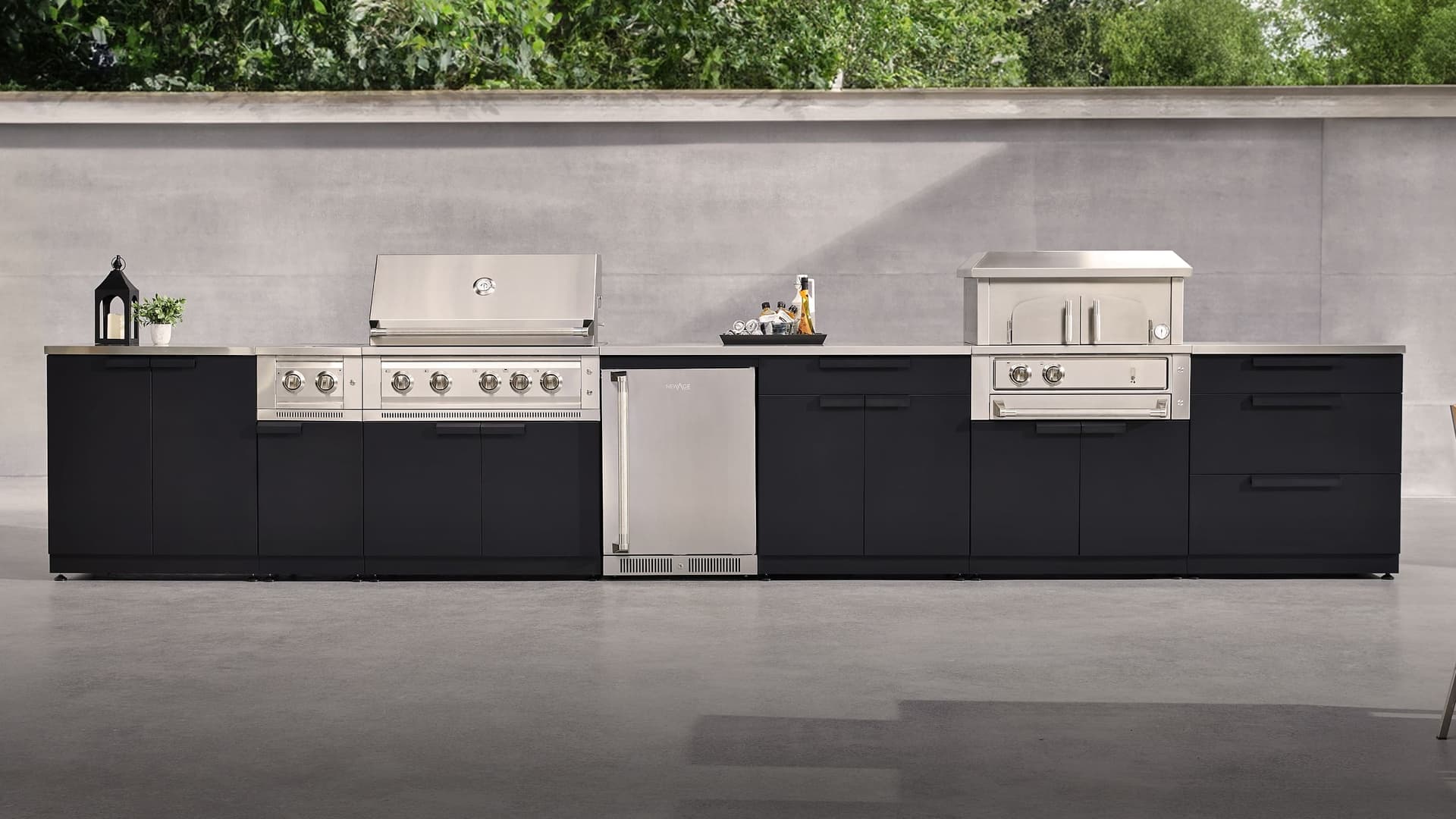 NewAge slate grey outdoor kitchen with a kamado grill, outdoor fridge and built-in gas grill