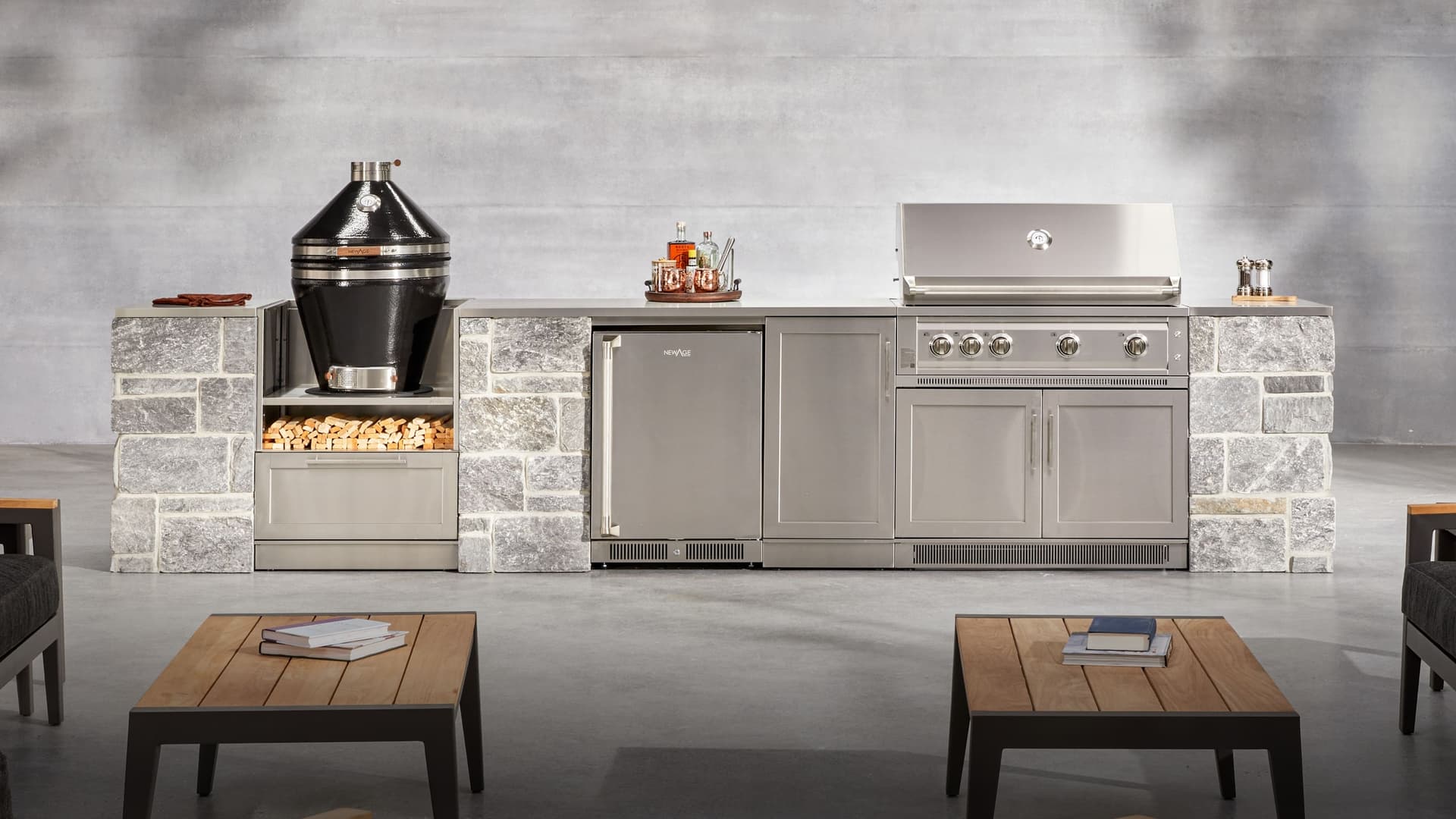 NewAge outdoor kitchen with stone-clad surrounds, a kamado grill and built-in gas grill