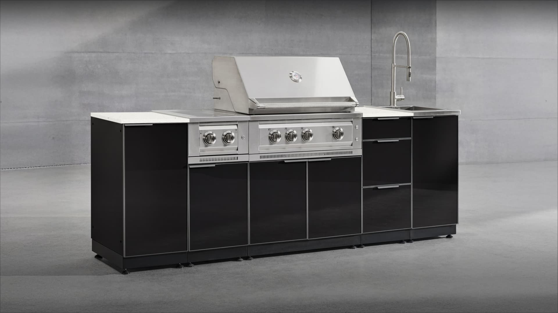 NewAge gloss black grill island with a white countertop, built-in gas grill and sink