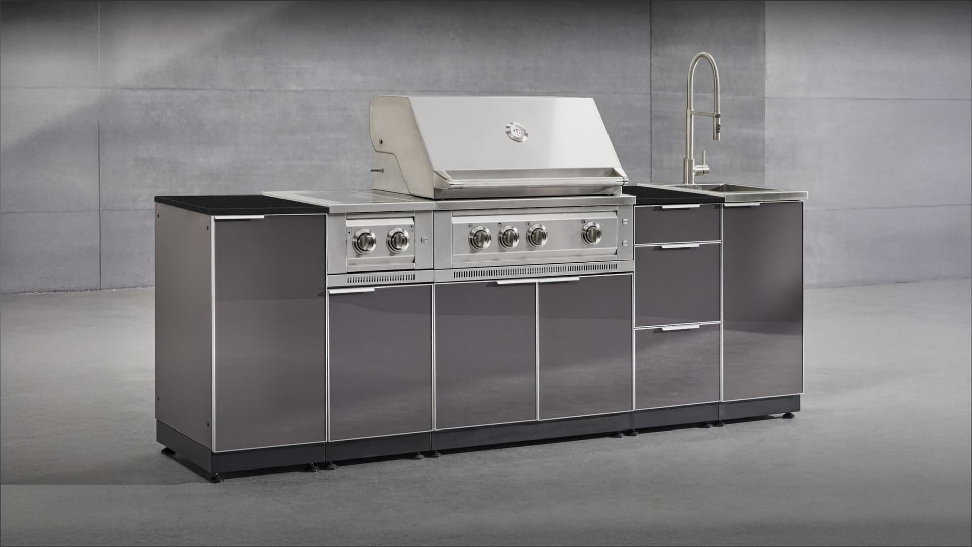 NewAge gloss grey grill island with a black countertop, built-in gas grill and sink