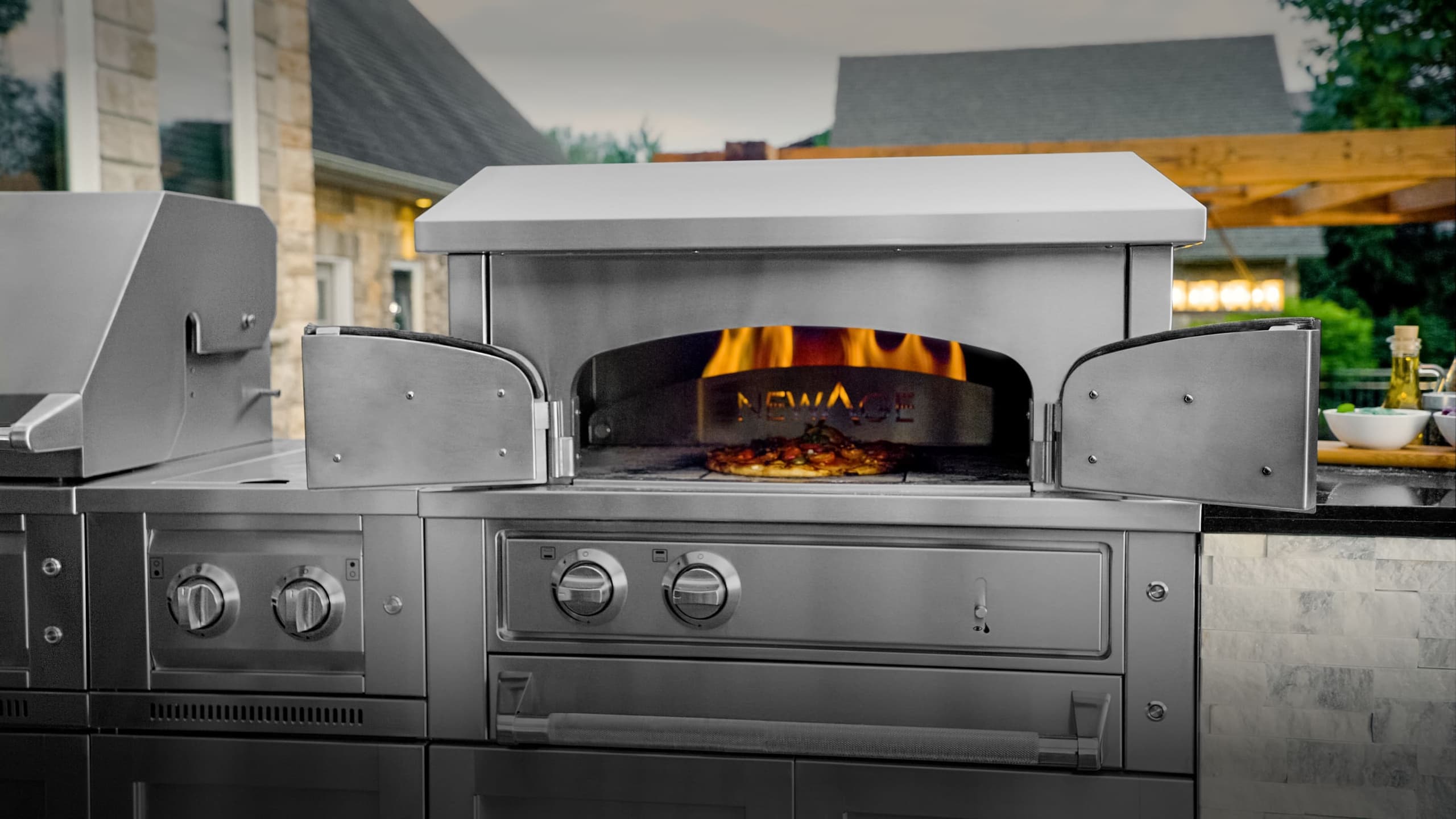 NewAge gloss grey grill island with a black countertop, built-in gas grill and sink