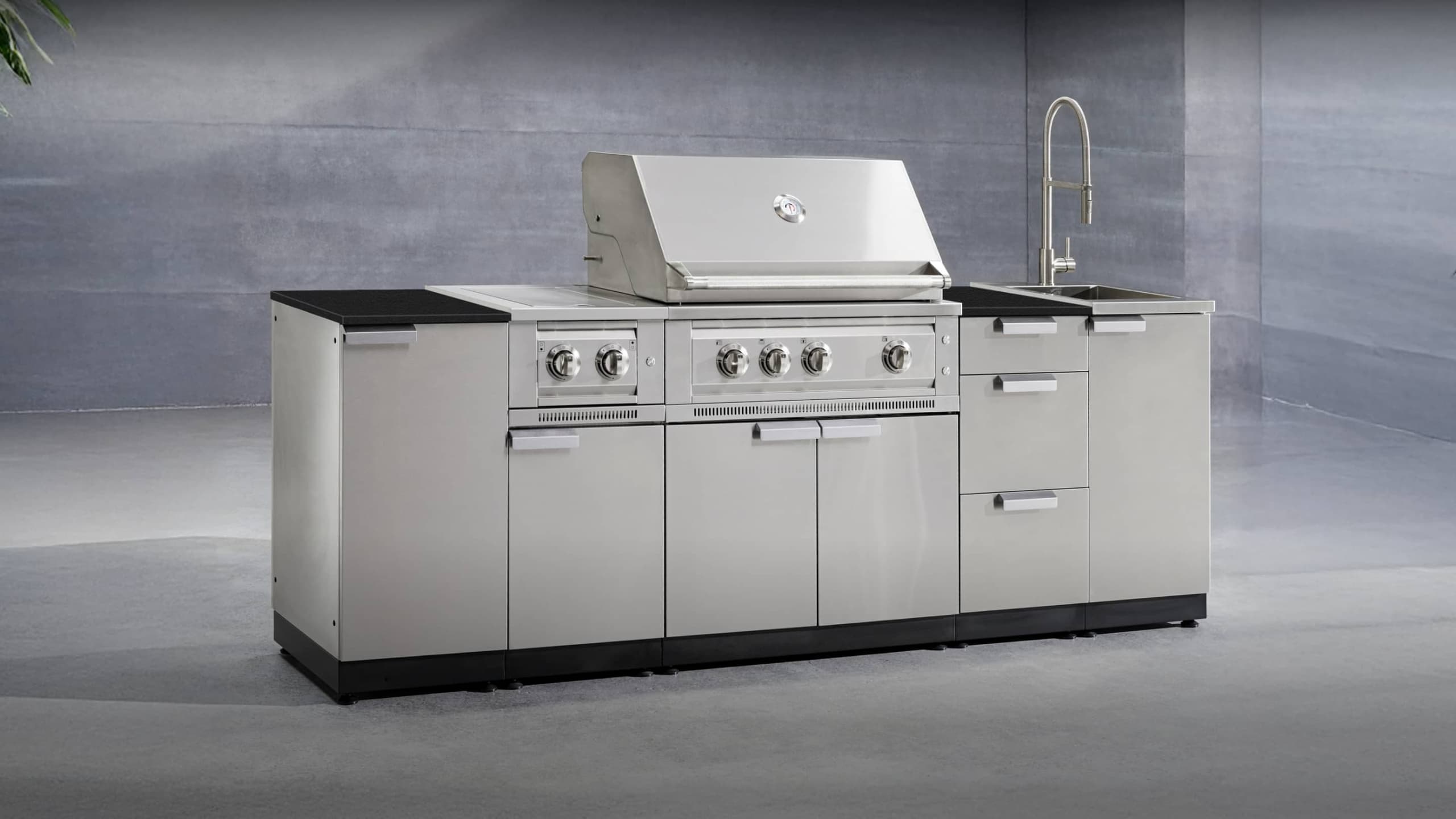 NewAge gloss black grill island with a white countertop, built-in gas grill and sink