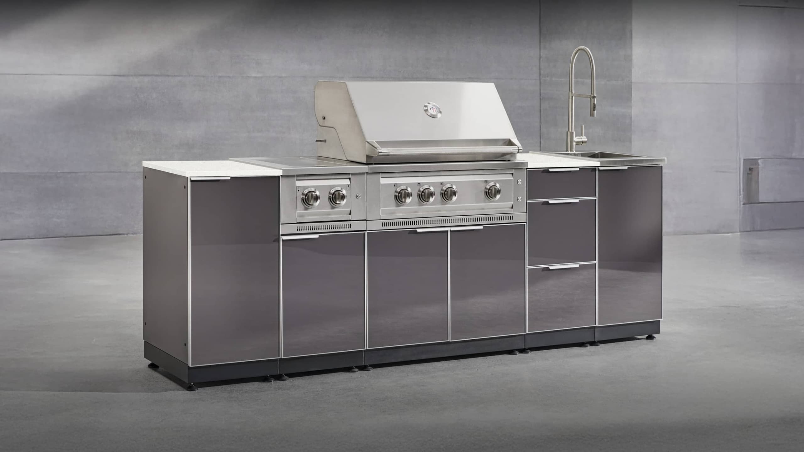 NewAge gloss black grill island with a white countertop, built-in gas grill and sink